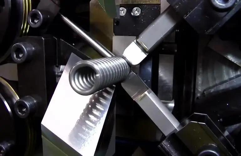 Precision torsion spring being formed on CNC coiling machine